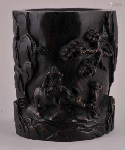 Hardwood brush pot. China. 20th century. High relief carving of a scholar on a buffalo with an attendant in a landscape.  5-3/4