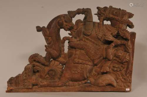 Architectural element. India. 19th century. Carving of a horse and rider riding down a tiger.  19