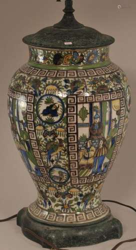 Pottery vase. Persia. Early 20th century. Chinoiserie decoration of figures in a palette of aubergine, blue, yellow and green. Drilled and mounted as a lamp. Height of vase- 13