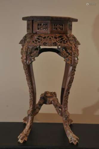 Tabouret. China. Late 19th century. Carved rosewood with a marble inset top. Carved and pierced with dragon, clouds, cash coins and bats, 35-1/2