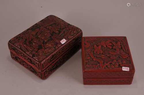 Two cinnebar boxes.  China. 19th to early 20th century. To include: A rectangular three colour box and a square one. Surfaces carved with figures in a landscape. (1) 5-1/4