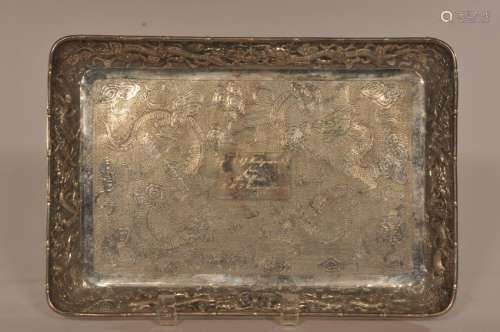 Silver Rectangular tray. China. Early 20th century. Repousse and engraved decoration of dragons and celestial pearls. Inscription reading: Capt. R.A.J. Montgomery CB from the officers. H.M.S. Boneventure. 1898-1900. Touch marks on the reverse.  7-3/4