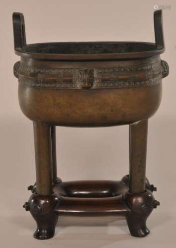Bronze censer. China. Hsuan te mark and possibly of the period. Fang Ting form with a band of animal heads and geometric archaic style designs. Fitted stand.  7 1/2