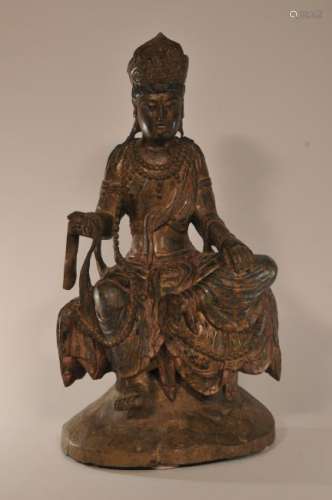 Wood carving. China. 19th century. Seated figure of Kuan Yin on a rocky throne.   20