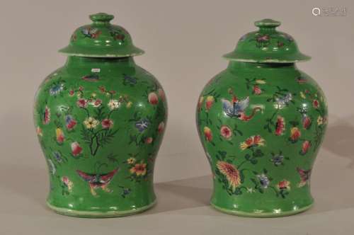 Pair of porcelain covered jars. China. 19th century. Export for the Straits Chinese market. Famille Rose decoration of insects, fruit and flowers on a bright lime green ground.  12