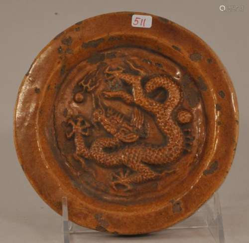 Round pottery Tile. China. Ming Dynasty. (1368-1644). Circular end tile with a dragon and pearl. Yellow glazed surface. 5-1/2