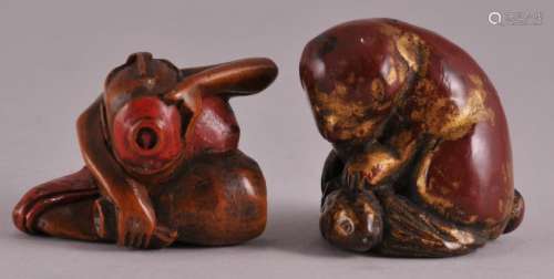Two Japanese carved wood and lacquer decorated Netsukes. (1) Crouching man eating from a bowl. Red Lacquer. Possibly signed on base. 1-1/8