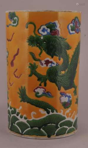 Porcelain brush pot. China. Early 20th century. Engraved decoration of dragons, clouds and waves in pink, red, blue and green on a yellow ground. 9-1/2