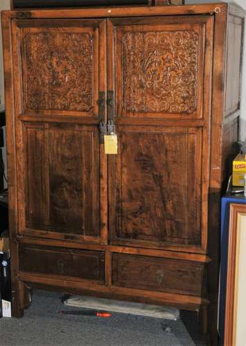 Elmwood cabinet. China 20th Century. Two cabinet doors, over 2 drawers. Floral carved door panels.69