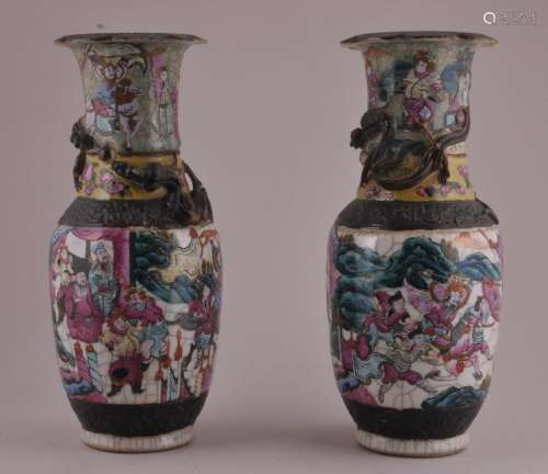 Pair of late 19th century Chinese Famille Rose decorated porcelain vases with applied dragons. Warrior decoration against Celadon and white crackle ground. 12
