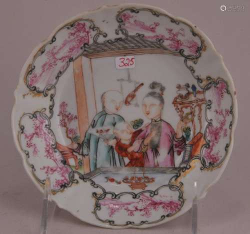 Porcelain saucer dish. China. Circa 1800. Famille rose decoration of a family scene. Borders of magenta landscape reserves.  5-1/2