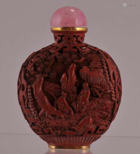 Cinnebar snuff bottle with pink stopper. Chibna. 19th century. Surface carved with figures in palace scenes. Ch'ien Lung mark on the base.  3-1/4