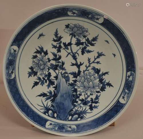 Porcelain charger. China. 19th century. Underglaze blue decoration of birds, butterflies and flowers.  18-1/2