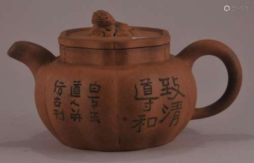 Pottery teapot. China. Early 20th century, Yi Hsing ware. Buff colored. Lobated body with inscriptions. Foo dog finial.   6-3/4
