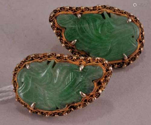 Pair of Jadeite earrings. China. Early 20th century. Carved leaf shaped with filigree gold mounts. 1-1/2