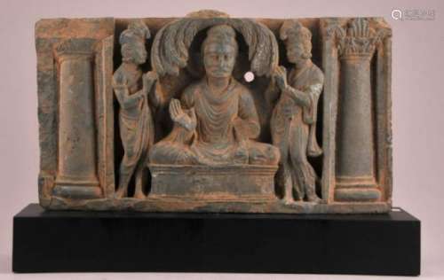 Carved stone fragment. North India. Gandharan period. 2nd c BC. Green Schist carved in relief with a Buddha and two Devotees. 13-1/2