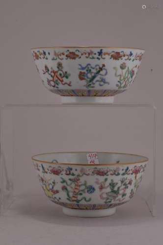 Pair of porcelain cups. China. 19th century. Famille Rose decoration of the emblems of the immortals and flowers and insects. Shen Te Tang mark on the base. 5