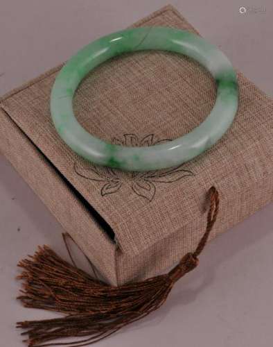 Hardstone bracelet. Jadeite green with emerald markings. Outer diameter- 3-1/2