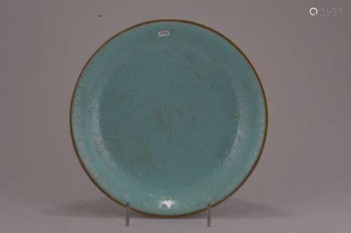 Porcelain dish. China. Late 19th century. Slip decoration of floral scrolling beneath a pale turquoise glaze. Ch'ien Lung mark on the base.  9