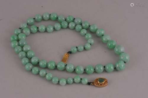 Chinese natural color apple green Jadeite graduated beaded necklace. G.I.A. report. Natural color. No indications of impregnation. 22-1/2