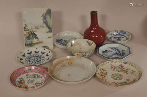 Lot of ten porcelains. China and Japan. Late 19th century. To include: four underglaze blue plates, four Famille Rose owls, a porcelain screen and an oxblood vase. Damage to all.  Vase 6 3/4