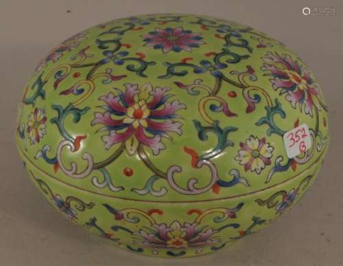 20th century Chinese lime green ground round covered porcelain box. Floral scroll decoration. Turquoise interior and base. Chien Lung mark on base. 4