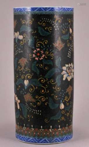Cloisonne on porcelain vase. Japan. Early 20th century. Cylindrical form. Stylized floral decoration on a black ground. 10