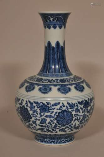 Porcelain vase. China. Ch'ien Lung mark but probably 19th century. Heaped and piled underglaze blue decoration of stylized floral scrolling and other floral elements. 12-1/2