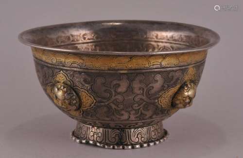 Parcel gilt silver cup. North Asian. 19th century or earlier. Repousse and engraved decoration. Interior with the Buddhist wheel of law set with a pearl.   4-1/4