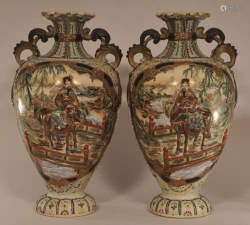Pair of early 20th century large Japanese Earthenware two handled vases with relief figural Samurai and moriage decoration. One vase repaired.   19