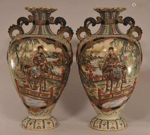 Pair of early 20th century large Japanese Earthenware two handled vases with relief figural Samurai and moriage decoration. One vase repaired.   19