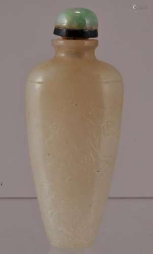 Jade snuff bottle. China. 19th century. Stone of a yellow white colour. Surface carved with flowering trees. Green Jadeite stopper. 2-1/2