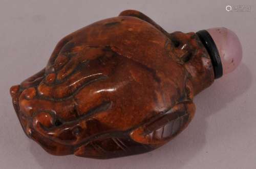 Root amber snuff bottle. China. 19th century. Carved as a Buddhas hand citron. 2