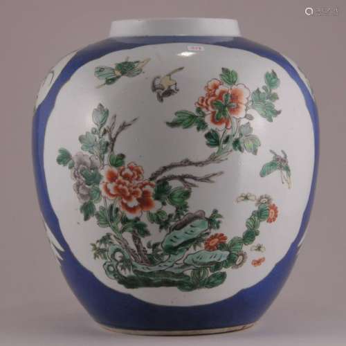 19th century Famille Verte and powder blue decorated large covered jar. Landscapes with floral, bird and butterfly decoration. Seated Chinese figure on cover. Kang Xi mark on base. .11-1/4