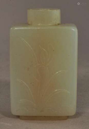 Jade snuff bottle.  China. 19th century. Even white stone. Rectangular square off form. Surface carved with floral sprigs.  2-1/8