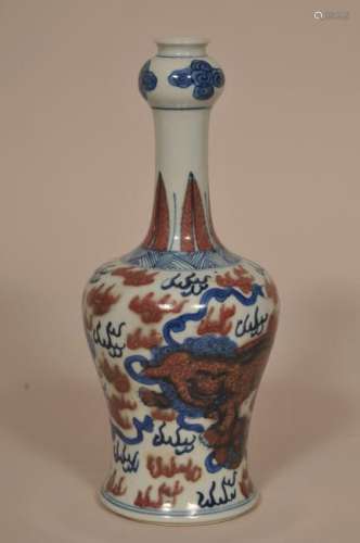 Porcelain vase. China. Late 19th century. Garlic mouth form. Underglaze blue and red decoration of foo dogs, brocade spheres and clouds. 10 Â¼