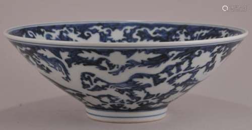 Porcelain bowl. China. Hsuan Te mark but late 19th century. Reverse type decoration of engraved dragons on a heaped and piled blue ground. 8-3/4