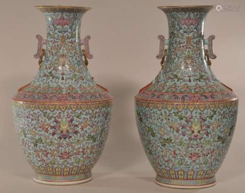 Pair of porcelain vases.  China. 19th century. Resonance stone handles. Decoration of stylized lotus scrolling on a pale turquoise ground. Drilled for lamps. 13-1/4