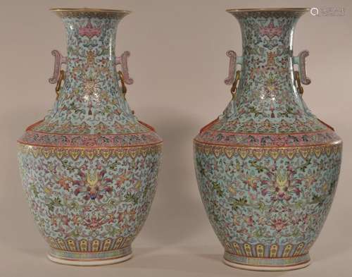 Pair of porcelain vases.  China. 19th century. Resonance stone handles. Decoration of stylized lotus scrolling on a pale turquoise ground. Drilled for lamps. 13-1/4