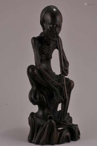 Hardwood carving. China. 20th century. Seated immortal playing a flute.  11-3/4