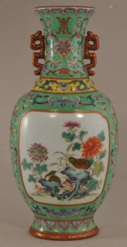 20th century Chinese green ground wall vase with Famille Rose quail decoration. Coral handles. Floral scroll decoration. Turquoise interior and base. Chien Lung mark on base. 7-1/2