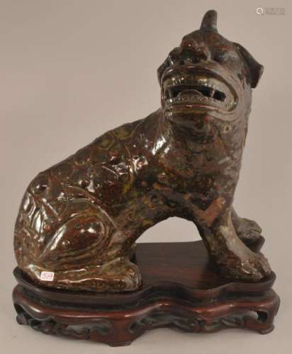 Stoneware animal. China. 19th century. Kuang Tung ware. Mythical animal with a brown glaze. Fitted hardwood stand.  9