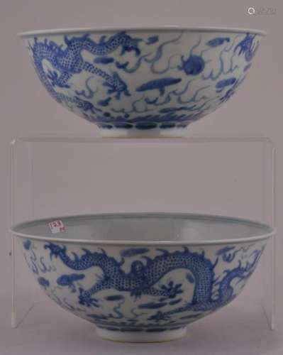 Pair of porcelain bowls. China. 19th to early 20th century. Underglaze blue decoration of dragons and pearls. Kang H si mark. 6 1/2