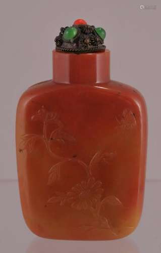 Agate snuff bottle. China. 19th century. Rectangular form. Stone of an amber colour. Surface carved with flowers. 2-1/4