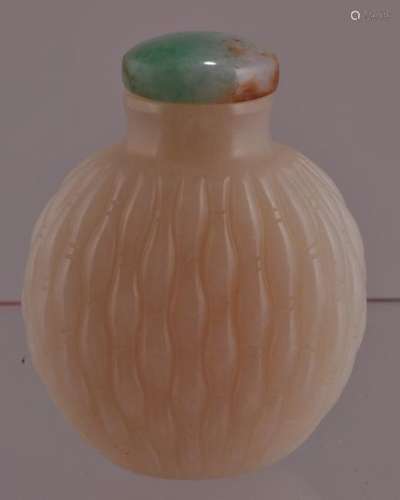 Jade snuff bottle. China. 19th century. White stone with a basket pattern carved surface.  2-1/2