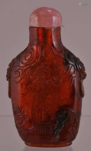 Amber snuff bottle. China. 18th/19th century. Surface carved with a landscape. Well hollowed.  2-3/4