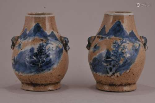 Pair of porcelain vases. China. Early 20th century. Pear shaped with foo dog handles. Underglaze blue landscape decoration on a crackled oatmeal coloured ground.  4 1/2