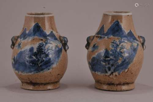 Pair of porcelain vases. China. Early 20th century. Pear shaped with foo dog handles. Underglaze blue landscape decoration on a crackled oatmeal coloured ground.  4 1/2