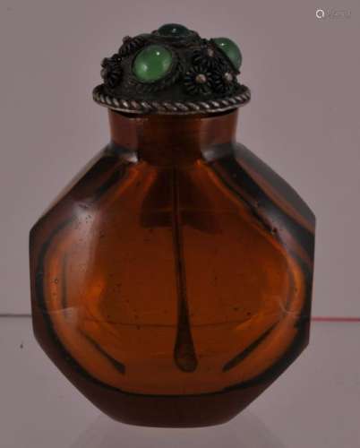 Peking glass snuff bottle. China. 20th century. Amber coloured glass with faceted sides.  2
