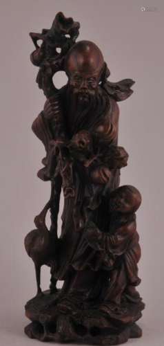 Wood carving. China. Mid-20th century. Figure of Shou Lao holding a bough of peaches with a small boy and crane by his side. 12